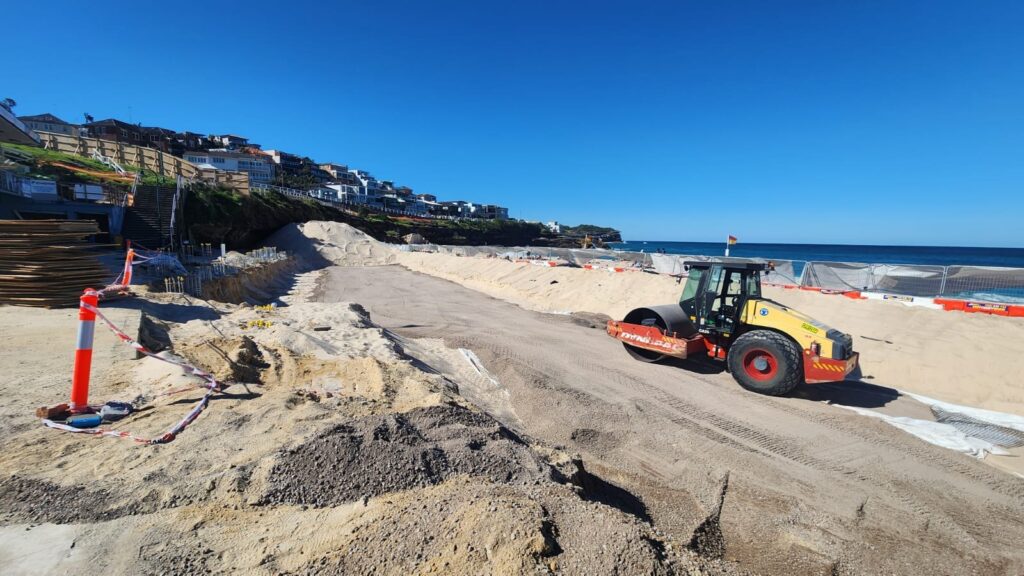 Compaction roller placing and compacting fill at Bronte, NSW